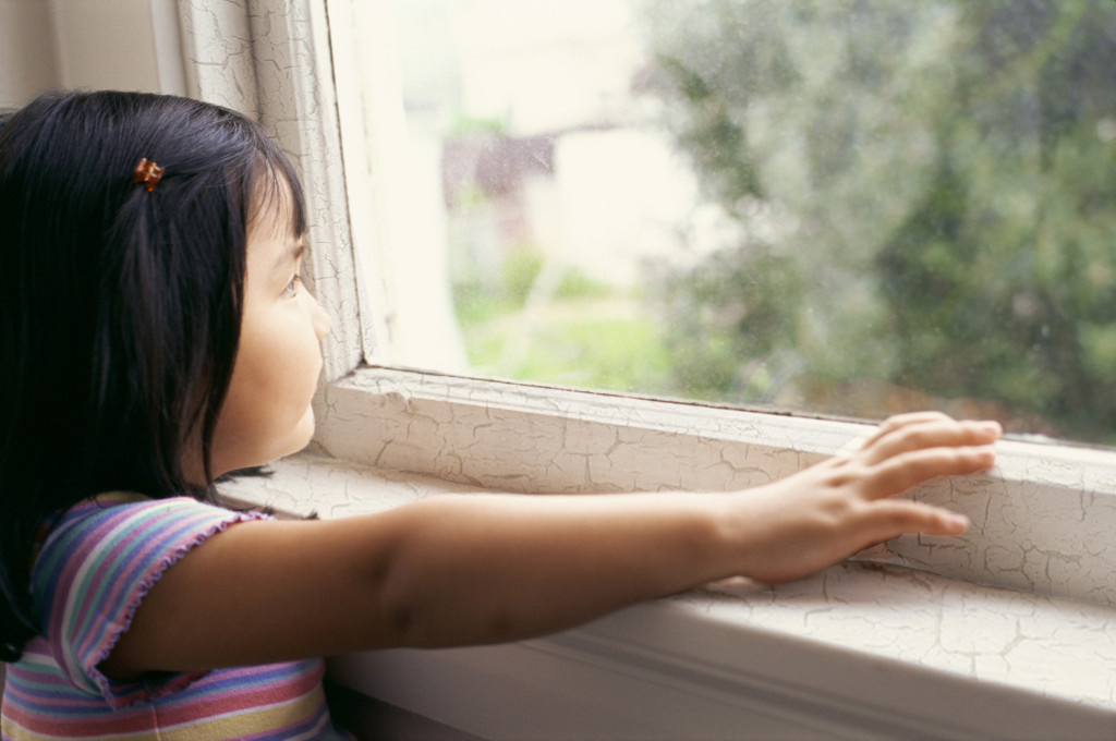 Girl looking out window